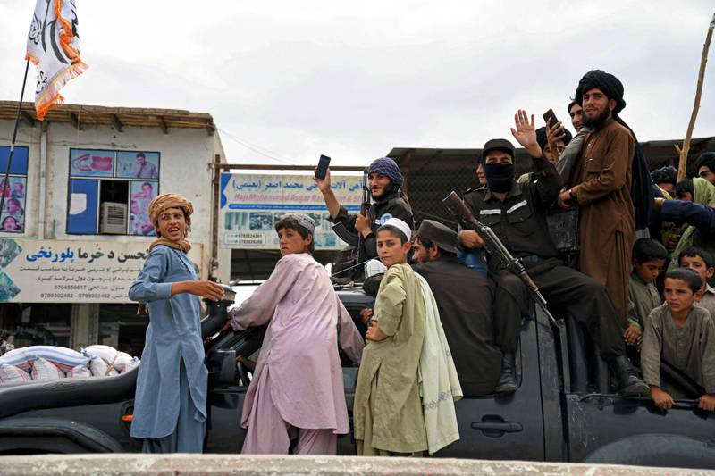 Taliban fighters and supporters during a parade in Kandahar.   AFP