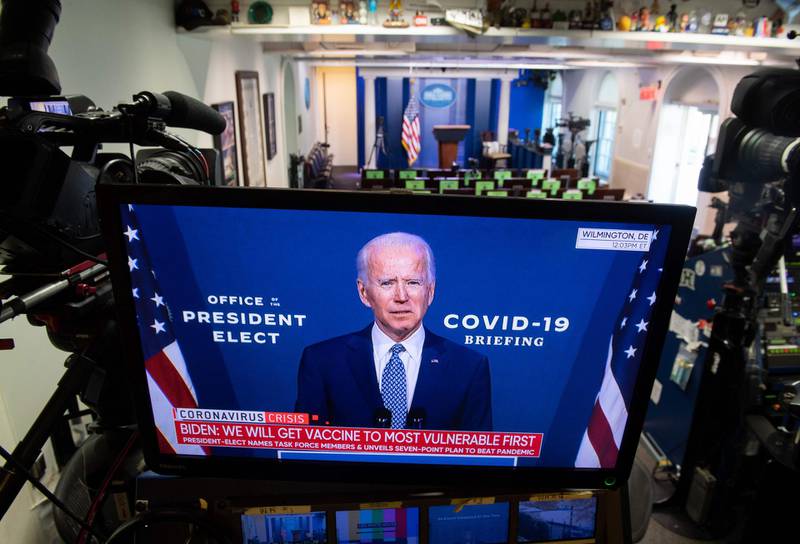 US President-elect Joe Biden speaks about coronavirus as he appears on a television in the Brady Press Briefing Room of the White House in Washington, DC.  AFP