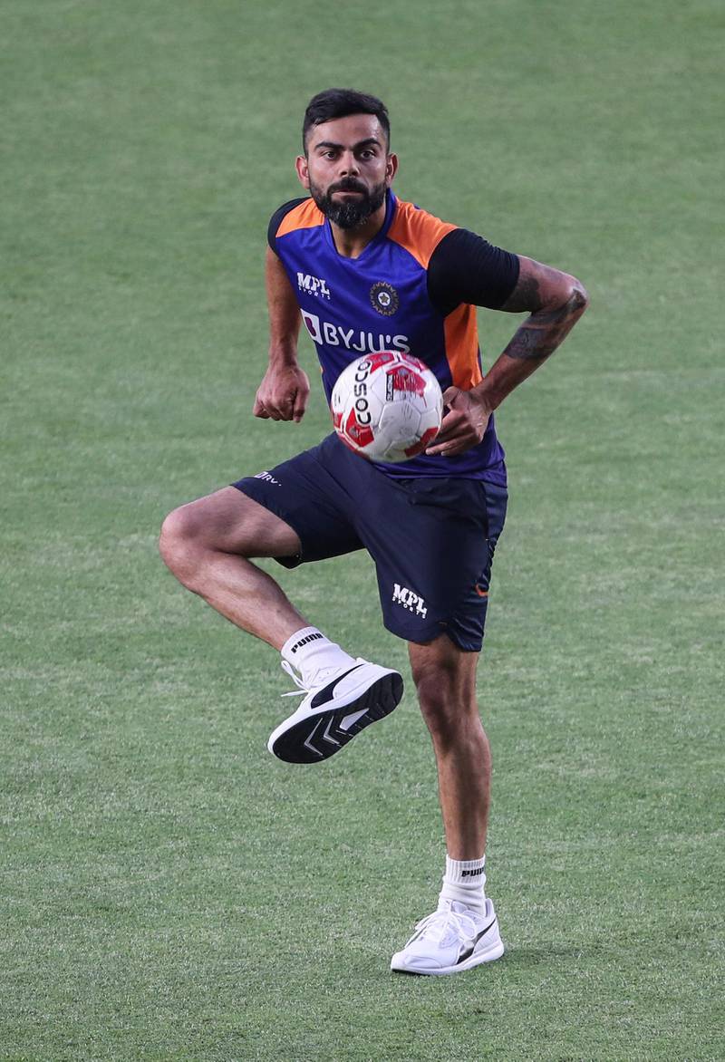 India captain Virat Kohli tests out his football skills during a warm-up session ahead of the first T20 match against England that takes place on March 12, at the Narendra Modi Stadium in Ahmedabad. PA