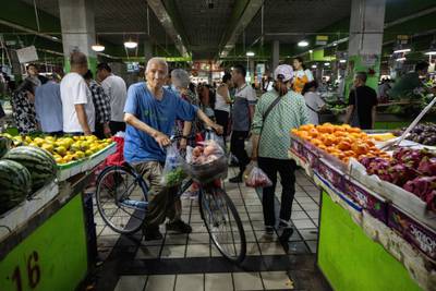 Customers at a wet market in Beijing. Food prices in China fell 1.7 per cent on year while non-food costs rose 0.5 per cent, led by rising costs linked to tourism. Bloomberg