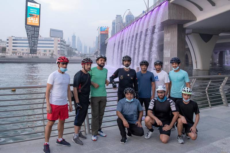The group pose for a photo by the canal bridge waterfall near Business Bay. Courtesy: Dubai Media Office
