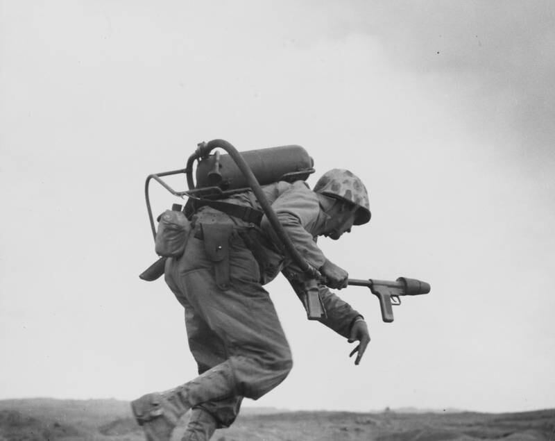 A US marine flamethrower operator with K Company goes over the top to assault a Japanese pillbox on Iwo Jima's second airfield on February 1945. Reuters