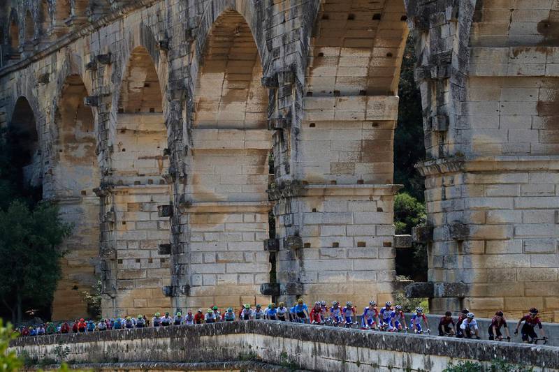 The peloton rides next to the Pont du Gard during the sixteenth stage of the Tour de France  in Nimes, France.  AP