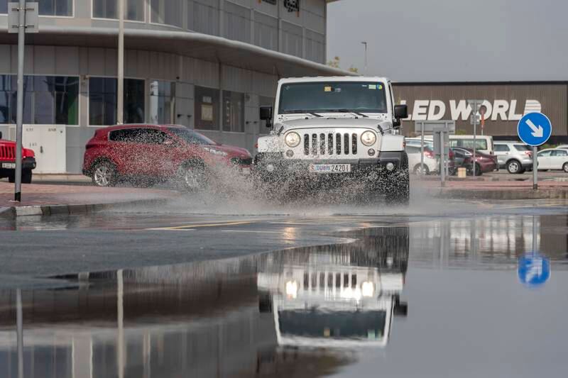 Cars drive through puddles in Dubai. Antonie Robertson / The National


