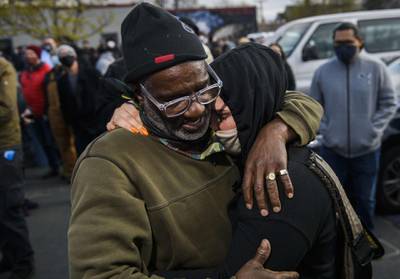 Charles McMillan and Genevieve Hansen, witnesses who testified in the trial, embrace in George Floyd Square after the verdict was read in the Derek Chauvin trial. AFP