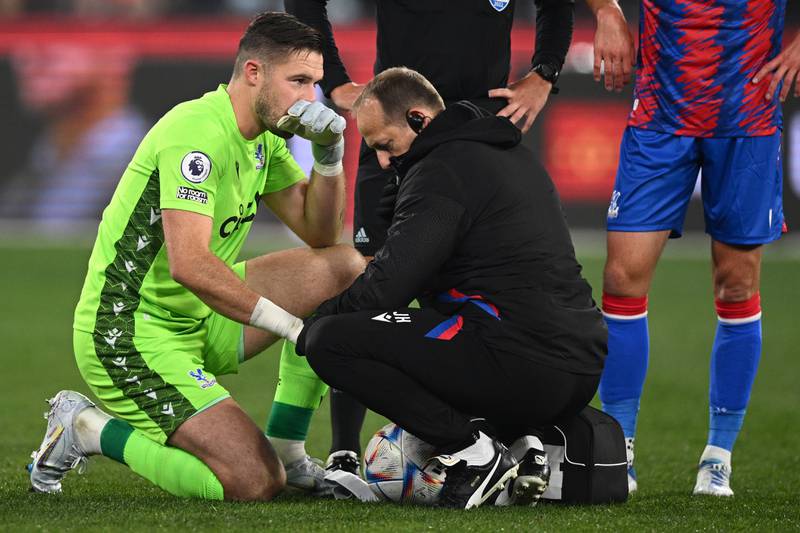 Palace goalkeeper Jack Butland is treated for a hand injury. EPA