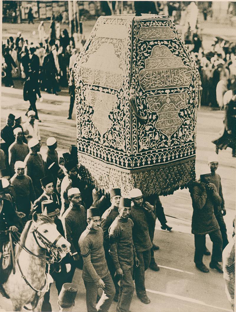 A photograph showing the Kiswah of the Maqam Ibrahim being carried through Cairo, in the presence of King Farouk; Egypt, 1939. Photo: The Khalili Collections