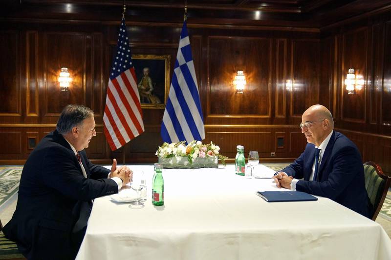 In this photo provided by the Greek Foreign Ministry, Greek Foreign Minister Nikos Dendias, right, and U.S. Secretary of State Mike Pompeo speak during their meeting in Vienna, Friday, Aug. 14, 2020. The State Department said Pompeo and Dendias discussed "the strong U.S.-Greece bilateral relationship and the urgent need to reduce tensions in the Eastern Mediterranean." (Charis Akriviadis/Greek Foreign Ministry via AP)