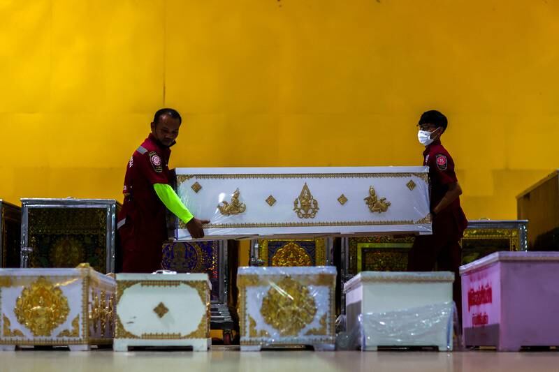 Rescue workers arrange coffins containing the body of victims at Song Serm Tham Foundation after transfer from Udon Thani hospital in Udon Thani province. Reuters