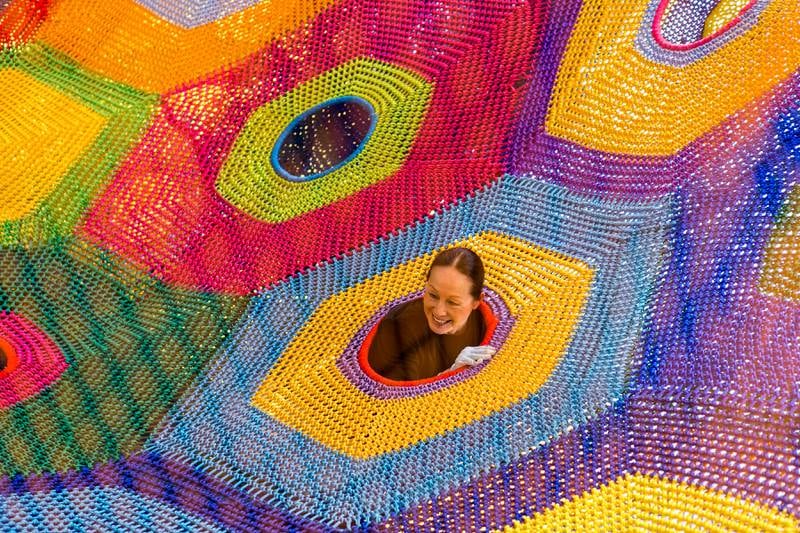 DUBAI, UNITED ARAB EMIRATES - AUG 3: 77 year old Japanese artist, Toshiko Horiuchi MacAdam, pops her head out of one of her net creations at a new play area in Dubai called OliOli.Toshiko creates nets made out of 800-1,000 kilos of nylon and weaves them into beautiful and inspiring art installations that are entirely interactive. (Photo by Reem Mohammed/The National)Reporter: Hala KhalafSection: AC