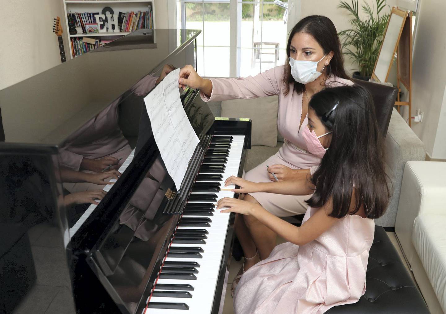 Former cabin crew Mercedes Basutto with student Hannah aged 8 was made redundant and has now switched careers as a piano teacher in Dubai on June 22nd, 2021. Chris Whiteoak / The National. 
Reporter: N/A for News