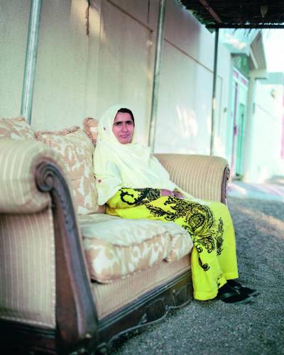 Moza Al Shamsi sits outside her house in Umm Ghafa. Courtesy Reem Falaknaz / National Pavilion UAE.
