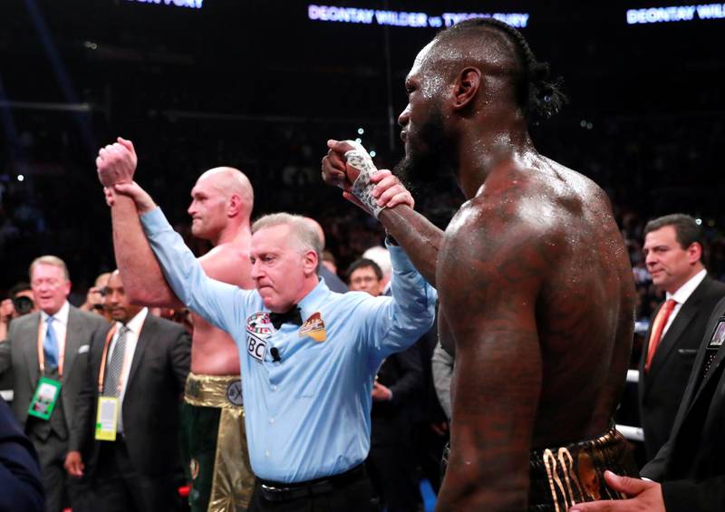 Deontay Wilder and Tyson Fury react after the fight. Reuters
