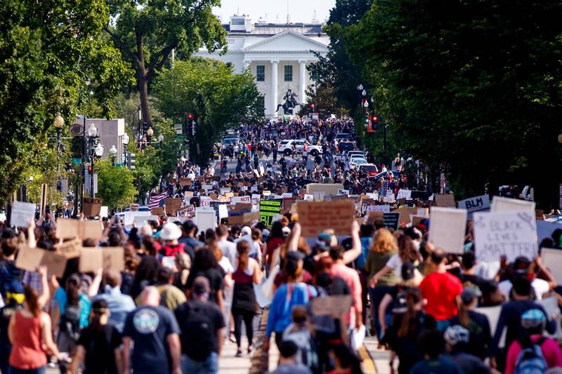 People, who gathered in protest against the death of George Floyd, peacefully march to the White House in Washington DC.  EPA