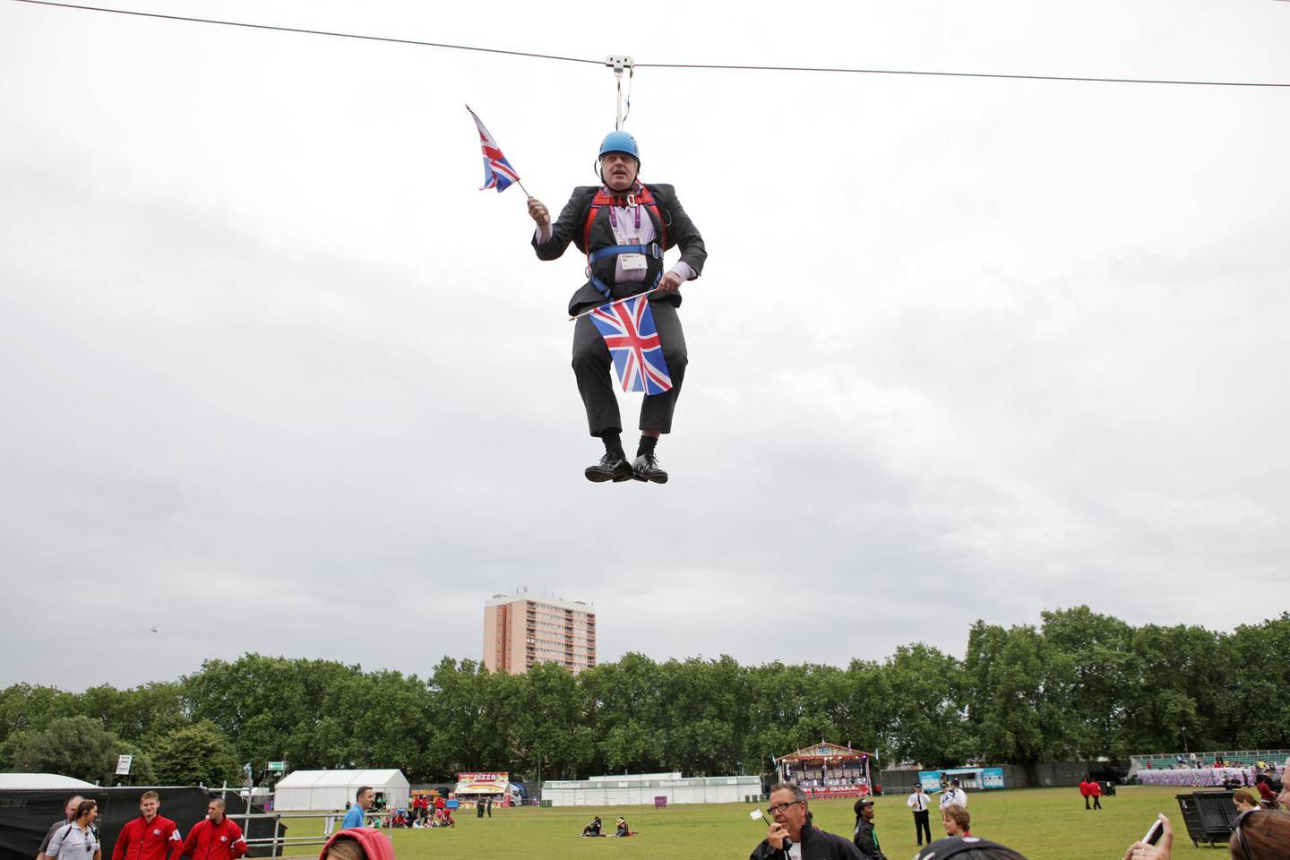 ***STOCK FILE IMAGE***LONDON, UNITED KINGDOM - AUGUST 01: Mayor of London Boris Johnson got stuck on a zip-line during BT London Live in Victoria Park on August 01, 2012 in London, England.

London Mayor Boris Johnson has proved he is ready to put his body on the line for a successful 2012 Olympics - but he might have gone too far in his latest stunt after getting stuck on a zip-line in Victoria Park. Mr Johnson was a guest at a BT London Live event at the east London park, where visitors can watch the Games action on a big screen or try their hand at a range of Olympic sports. But the mayor quickly became a major talking point on Twitter after pictures taken by people at the park surfaced of him dangling awkwardly from the wire, while brandishing a couple of Union flags. Several pictures showed Mr Johnson hanging from a harness wearing a blue helmet while waving the flags, although it is uncertain whether he was intending to stop where he did - or if it was a true zip-line malfunction. Earlier this week a poll of Conservative voters suggested the mayor was their top choice to succeed David Cameron as prime minister. He has so far enjoyed a high-profile Games, kicked off by addressing 60,000 people in Hyde Park on the day of the opening ceremony by taunting Republican presidential nominee Mitt Romney over his comments apparently doubting London's readiness to host.

PHOTOGRAPH BY Barcroft Media

UK Office, London.
T +44 845 370 2233
W www.barcroftmedia.com

USA Office, New York City.
T +1 212 796 2458
W www.barcroftusa.com

Indian Office, Delhi.
T +91 11 4053 2429
W www.barcroftindia.comPHOTOGRAPH BY  / Barcroft Media 

London-T:+44 207 033 1031 E:hello@barcroftmedia.com -
New York-T:+1 212 796 2458 E:hello@barcroftusa.com -
New Delhi-T:+91 11 4053 2429 E:hello@barcroftindia.com www.barcroftmedia.com (Photo credit should read Barcroft Media / Barcroft Media via Getty Images)