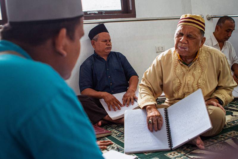 Blind Muslims read the Quran in braille in Medan, Indonesia, during the holy month. AFP