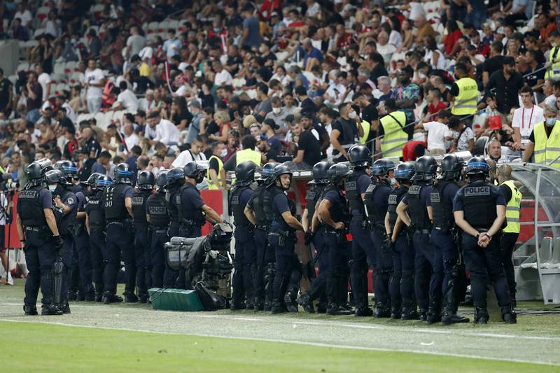 Police stand guard as the game is interrupted. Reuters