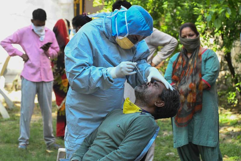 A doctor takes a sample from man for a Covid-19 test during a government-imposed lockdown as a preventive measure against the coronavirus, in Amritsar. AFP