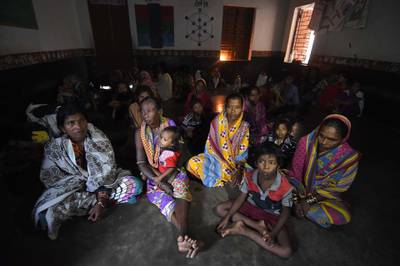 Villagers look on at a shelter near Berhampura during Cyclone Titli. AFP