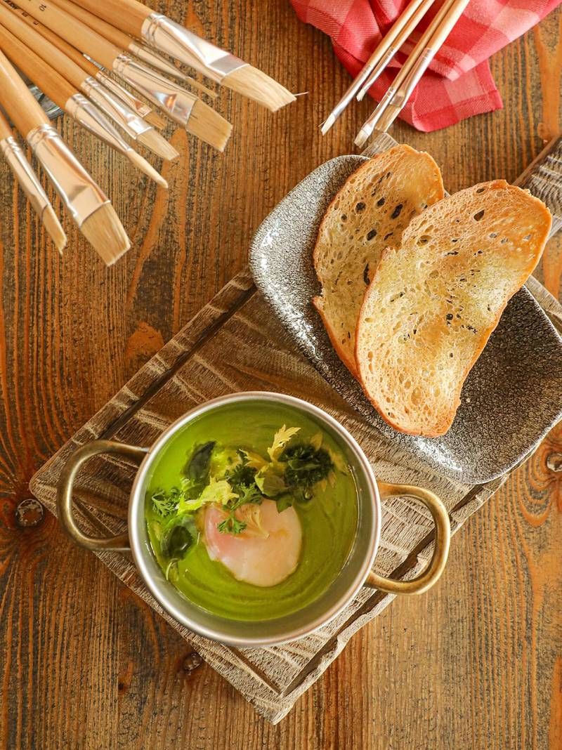 Claude Monet, a green pea veloute with a soft boiled egg and herb salad, is inspired by The Luncheon, a painting featuring a family lunch scene with the same ingredients