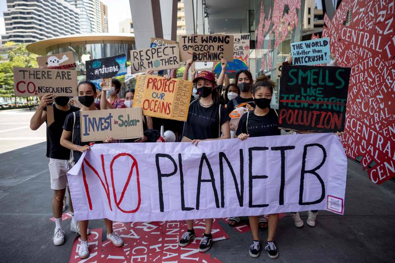 Young protesters carry placards as they take part in a ‘Climate Strike’ march towards Thailand’s Ministry of Natural Resource and Development to mark Earth Day in Bangkok. AFP