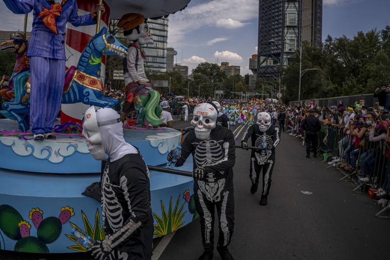 Participants dressed in costume during the Day of The Dead parade in Mexico City. Bloomberg