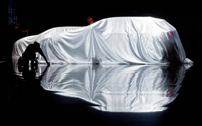 A covered Infiniti being readied for at opening day of the Frankfurt International Motor Show. Boris Roessler / EPA