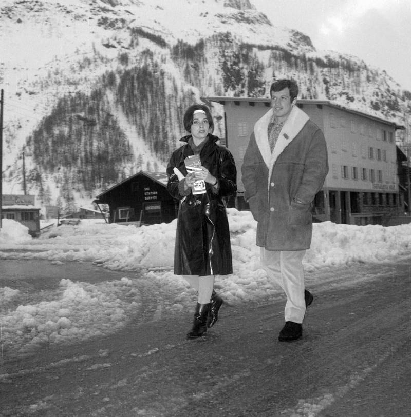 In this photograph taken on December 7, 1961, actor Jean-Paul Belmondo and his wife Elodie walk through the streets of Val d'Isere in December 1961. After finishing shooting his last film in Spain and the Canary Islands, Belmondo, one of post-war French cinema's biggest stars, has died aged 88. AFP