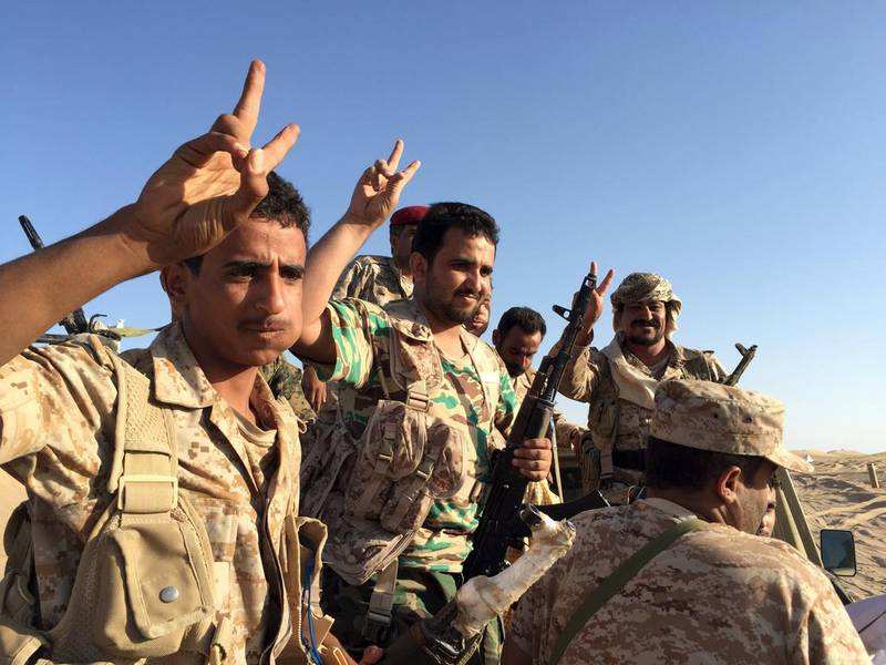 A group of soldiers trained by Emirati and Gulf Arab forces flash the victory sign near a military base in Marib province. Yemeni troops and Gulf special forces have captured several areas around Sirwah district in Marib since a military offensive in the province began on Sunday. Noah Browning / Reuters