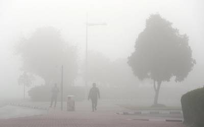 DUBAI, UNITED ARAB EMIRATES , Feb 16  – 2020 :-  One of the person doing morning walk during the early morning fog in Discovery Gardens area in Dubai.  (Pawan  Singh / The National) For News/Online/Instagram. 