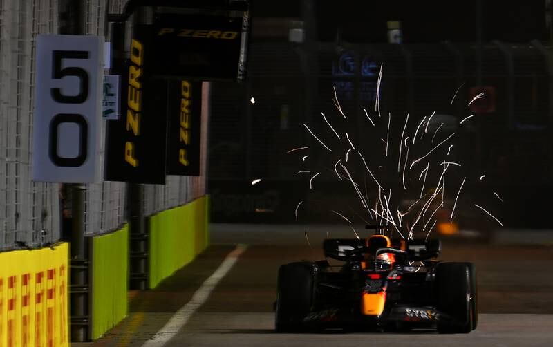 Sparks fly from the car of Max Verstappen at Marina Bay Street Circuit on October 1, 2022. Getty