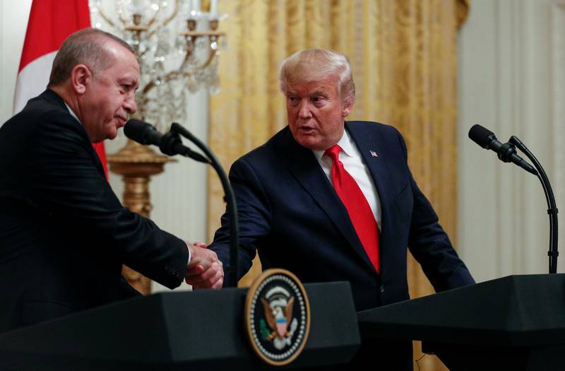 FILE PHOTO: U.S. President Donald Trump and Turkish President Tayyip Erdogan shake hands during a joint news conference at the White House in Washington, November 13, 2019. REUTERS/Tom Brenner/File Photo
