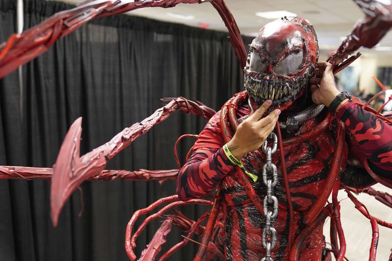 Fabian Pulgar dons the mask to his Carnage costume at the New York Comic Con. Seth Wenig / AP Photo
