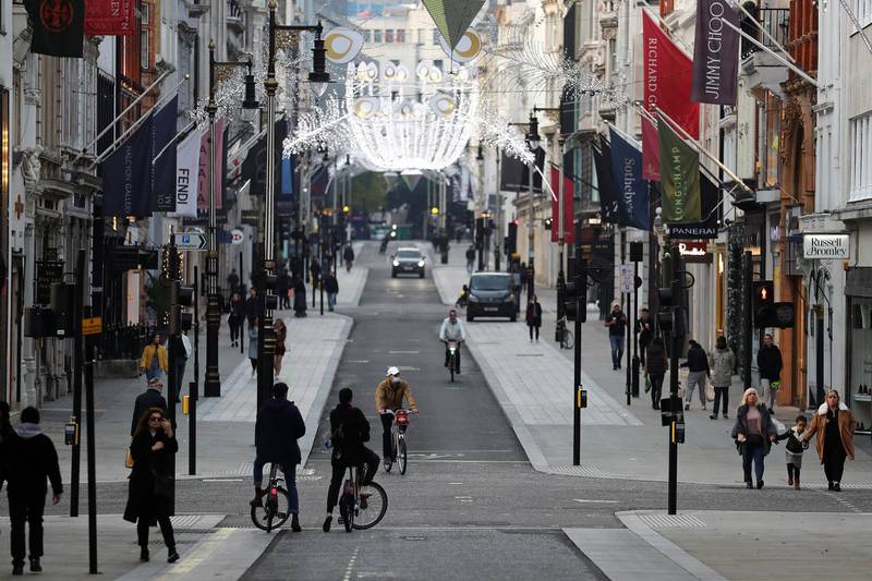 Pedestrians and cyclists move through New Bond Street in London. Reuters