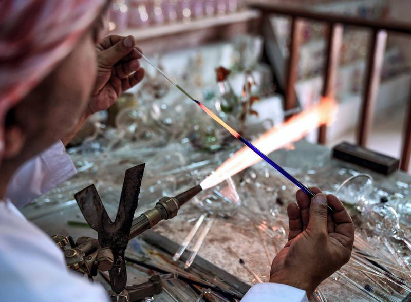 Abu Dhabi, United Arab Emirates, July 23, 2019.  VB:  Photo project at the Heritage Village, Corniche.  Local craftsworkers conduct workshops in traditional metalwork, pottery, glass blowing and Arabic cloak making. --  Noor Ahmad-47, Arabic glass blowing artist busy in his workshop at Heritage Villlage.Victor Besa/The NationalSection:  NAReporter: