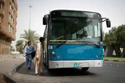 Abu Dhabi - July 3, 2008. A bus pulls up to a stop on Airport rd and Al Saada street. ( Philip Cheung / The National ) *** Local Caption ***  PC0022-Bus.jpgPC0022-Bus.jpg