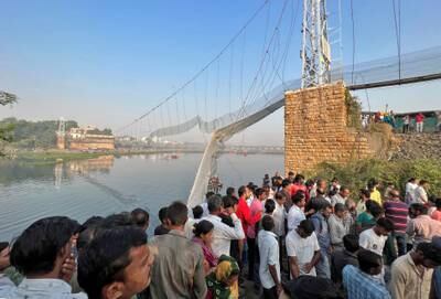 People gather as rescuers search for survivors after the suspension bridge collapse in Morbi, western Gujarat state. Reuters