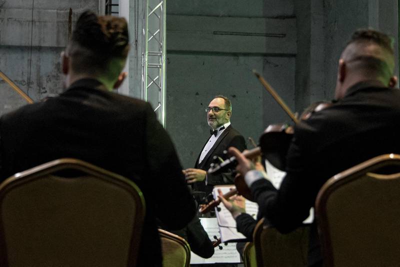 Conductor Mohammed Mahmoud leads the Watar orchestral ensemble at Mosul's Al Rabea Theatre. AFP