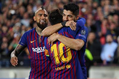 Lionel Messi celebrates with Luis Suarez. Catherine Ivill / Getty Images