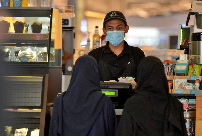 Women pick up their order from a restaurant in a shopping mall in the Saudi capital Riyadh. AFP
