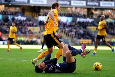 Tottenham Hotspur's Son Heung-Min goes down after a challenge by Wolverhampton Wanderers' Craig Dawson. PA 