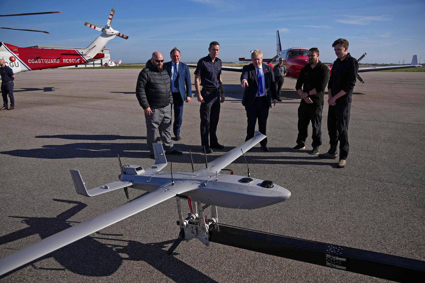 Prime Minister Boris Johnson views a Coastguard drone used for surveillance at Lydd Airport in Dover, England. AFP