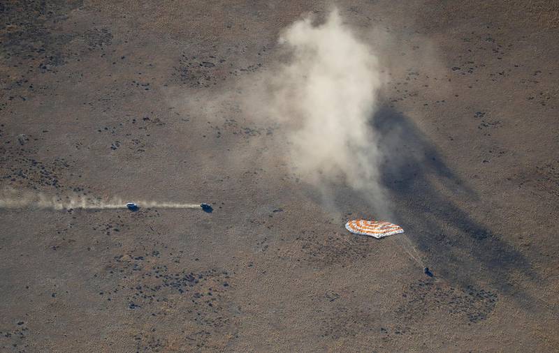 Rescue vehicles approach the capsule. AP Photo