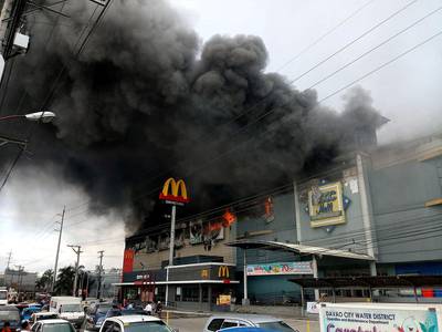 Smoke billows from a shopping mall on fire in Davao City, the Philippines, in this December 23, 2017 photo obtained from social media. Yas D Ocampo / Reuters
