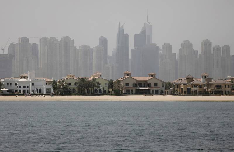FILE - In this June 6, 2018 file photo, Jumeirah Palm Island luxury villas are seen by their private beaches in Dubai, United Arab Emirates. Dubai's ruler has issued a directive to curb the pace of new real estate construction projects amid falling demand and property prices. On Monday, Sept. 2, 2019, Sheikh Mohammed bin Rashid Al Maktoum ordered the creation of a committee to study the needs of the real estate market, evaluate all future projects and control the pace of projects so supply does not outstrip demand. (AP Photo/Kamran Jebreili, File)