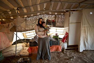 Bushra Eidah,16, holds her daughter Salam, 5 months old.
