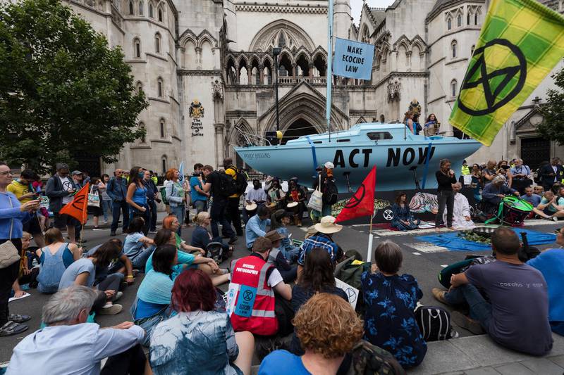 epa07718710 Extinction Rebellion climate change protesters block the road and demonstrate outside the Royal Courts of Justice in London, Britain, 15 July 2019. Climate change protests are taking place across five UK cities this week in a series of 'Summer Uprising' actions that are calling for the government to act on cutting emissions.  EPA/VICKIE FLORES