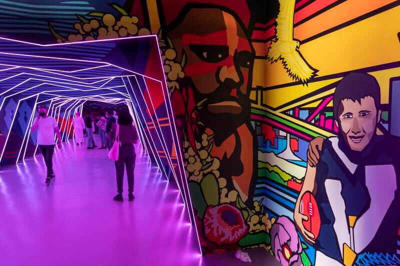 People walk through a mural-lined tunnel inside the Australian Pavilion at Expo 2020 Dubai. Photos: Antonie Robertson / The National