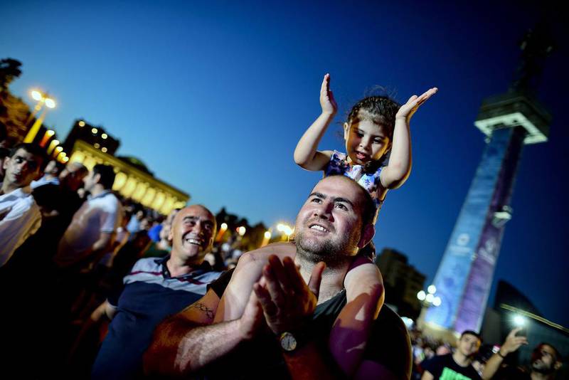 People watch the opening ceremonies for the inaugural European Games on Friday in Baku, Azerbaijan. Srdjan Suki / EPA