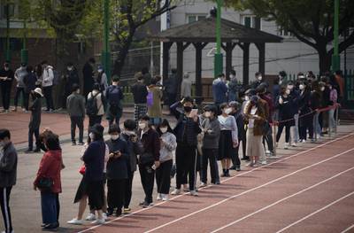 Voters wait in line to cast their ballots in Seoul, South Korea. Reuters